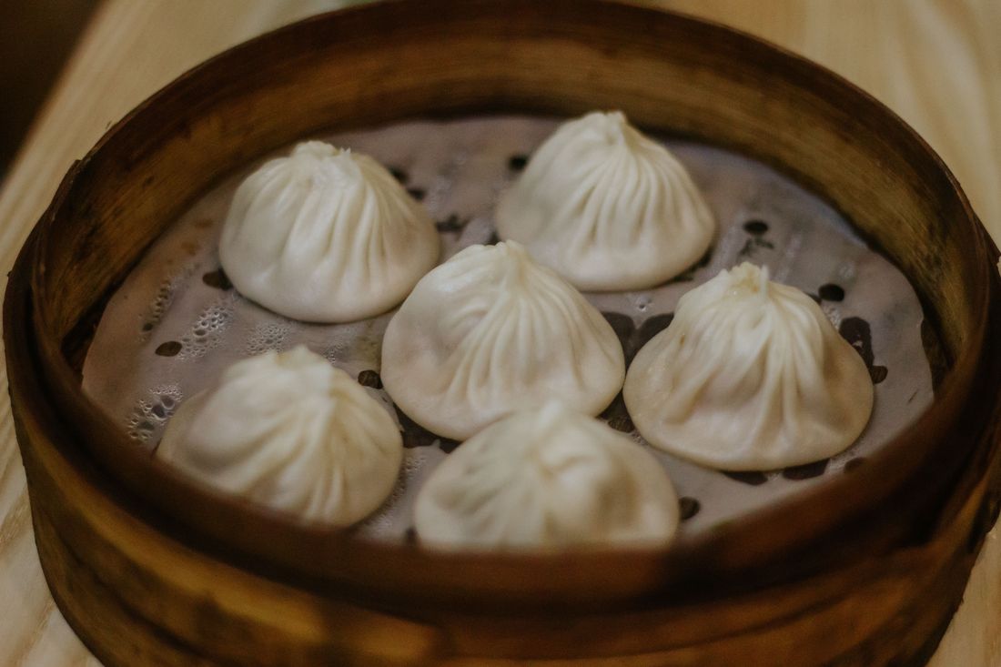 Xiaolongbao soup dumplings in a bamboo steamer